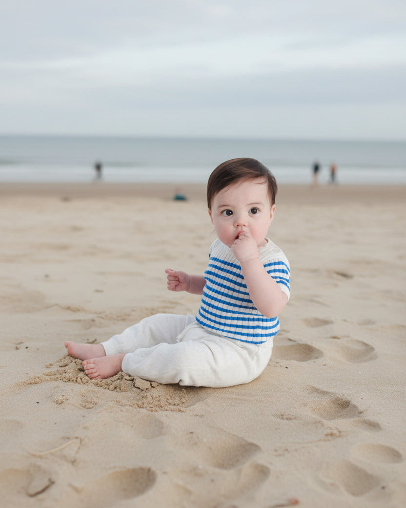 baby wearing marinière top and sitting at the beach